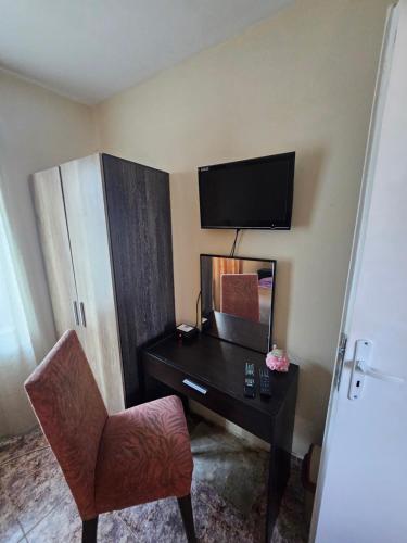 a room with a desk and a chair and a television at Libera in Sofia