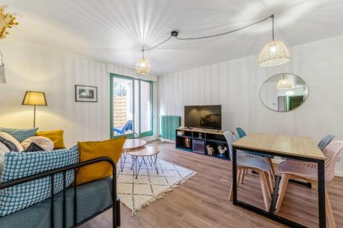 un salon avec un canapé et une table dans l'établissement Appartement du Thiou - Welkeys, à Annecy