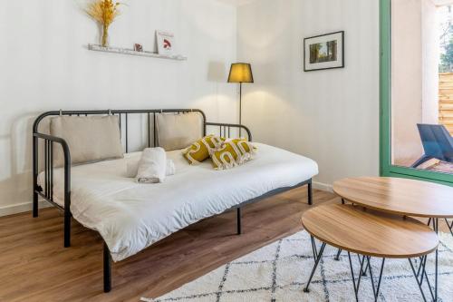 - un lit avec des oreillers jaunes dans l'établissement Appartement du Thiou - Welkeys, à Annecy