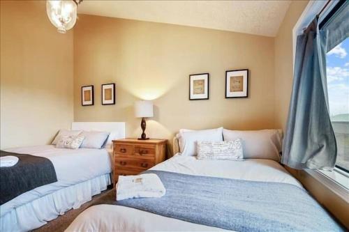 a bedroom with two beds and a window at Eola Crest Farmhouse in McMinnville