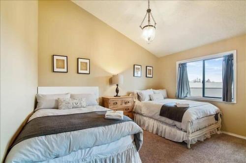 a bedroom with two beds and a window at Eola Crest Farmhouse in McMinnville