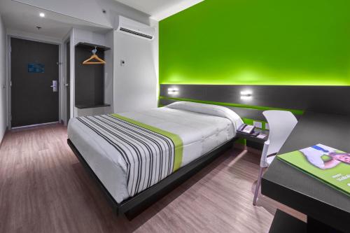 Ένα ή περισσότερα κρεβάτια σε δωμάτιο στο City Express Junior by Marriott Bogota Aeropuerto