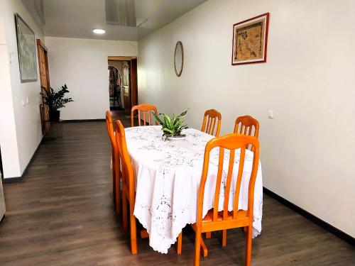 a dining room with a table with orange chairs at TAHITI - Vetea POOL Fare in Pirae