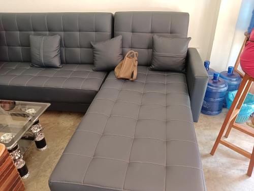 a couch in a living room with a purse on it at Annie Backpacker Hostel in Ban Nongdouang