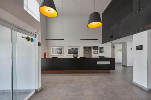 a lobby with yellow lights and a reception desk at City Express by Marriott Cananea in Cananea