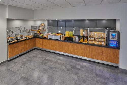 a restaurant with a counter with food on it at City Express by Marriott Matamoros in Matamoros