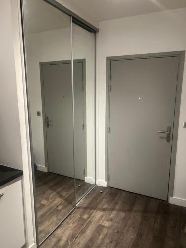 - deux portes en verre dans une chambre dotée de parquet dans l'établissement EFA, à Villeurbanne