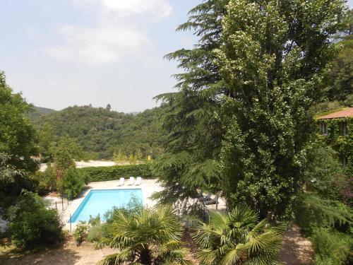 - une vue sur la piscine depuis le jardin dans l'établissement Appartement 10 Des Acacias, à Anduze