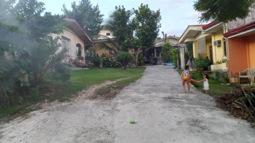 two children playing in the driveway of a house at Bohol Stays in Tagbilaran City