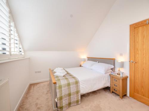 a small bedroom with a bed and a window at Arenig View - Uk46081 in Frongoch
