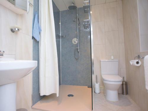a bathroom with a shower with a toilet and a sink at 4 Bed in Thirsk 49481 in Thirsk