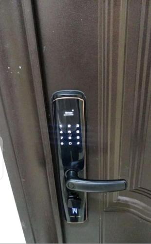 a glass door with a cell phone on it at Apartment B16 in Port Harcourt