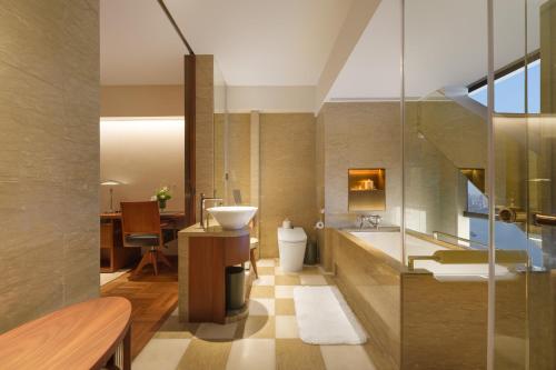 a bathroom with a sink and a toilet at Maxx by Steigenberger on the Bund Shanghai in Shanghai