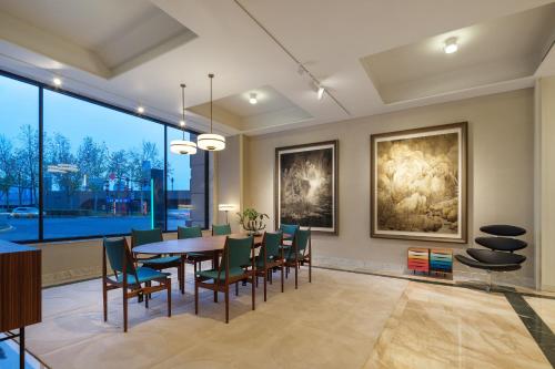 a dining room with a table and chairs at Maxx by Steigenberger on the Bund Shanghai in Shanghai