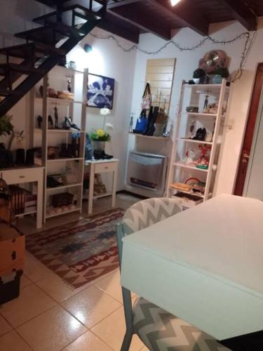 uma sala de estar com uma mesa branca e prateleiras em El Refugio al Norte del Fin del Mundo em Rio Grande