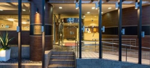 a lobby of a building with a staircase in front at Urvest Hotel Kamata in Tokyo