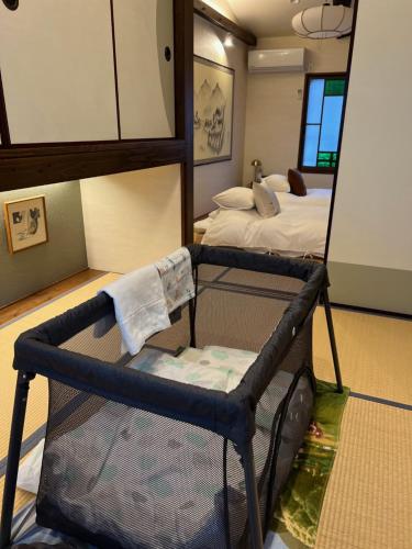 a room with a mirror and a crib with a bed at Imakumano Terrace - Mokubei An 木米庵 in Kyoto