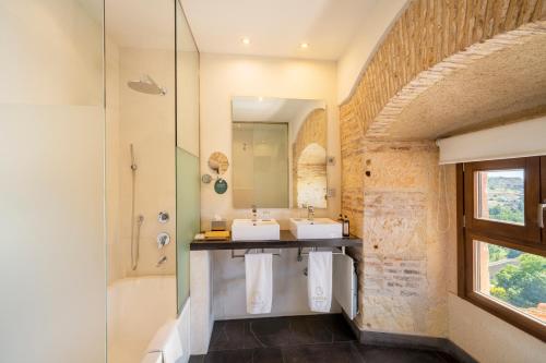 a bathroom with two sinks and a shower at Áurea Convento Capuchinos by Eurostars Hotel Company in Segovia
