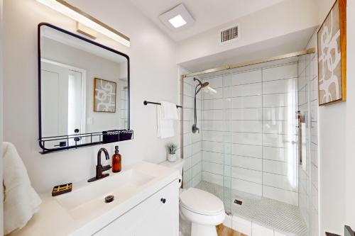 a bathroom with a shower and a toilet and a sink at Grand Palms in Scottsdale