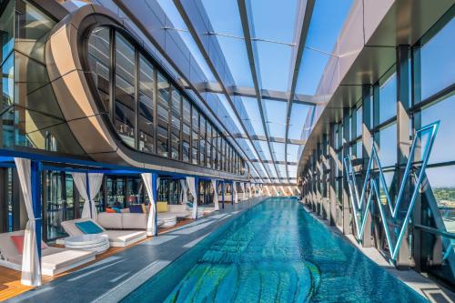 a swimming pool in a building with a glass ceiling at W Sydney in Sydney