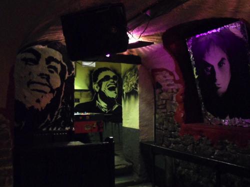 a dark room with posters on the walls at Hajo´s Germania Lodge & Irish Pub in Rüdesheim am Rhein