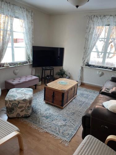 a living room with a couch and a coffee table at Villa Avaborg in Burträsk