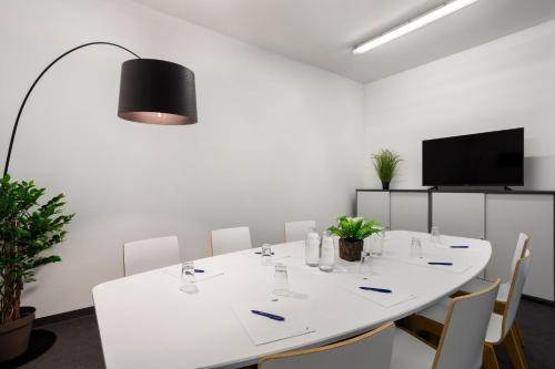 a conference room with a white table and chairs at Holiday Inn Express Munich City West by IHG in Munich