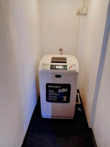 a dustbin sitting in a corner of a room at Villa Yuvin in Matara