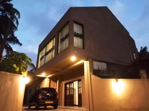 a building with a car parked in front of it at Villa Yuvin in Matara