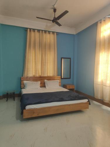 1 dormitorio con 1 cama con paredes azules y techo en S house, en Guwahati
