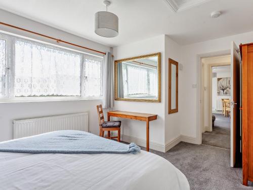 een slaapkamer met een bed, een bureau en een raam bij 2 bed in Bath 05135 in Chew Magna