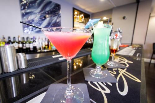 two cocktails in glasses sitting on a bar at Dalmeny Hotel in Lytham St Annes