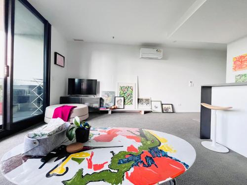 a living room with a large rug on the floor at Lakeside Apartment with Great Views in Belconnen