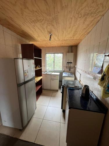 a kitchen with a refrigerator and a counter top at ¡Casa equipada para vacacionar! in Viña del Mar
