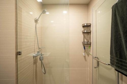 a bathroom with a shower with a glass door at Luxury Condo at Venice Mall near Airport, BGC & Makati in Manila