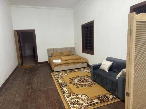 a living room with a couch and a bed at ML rental Battambang in Battambang