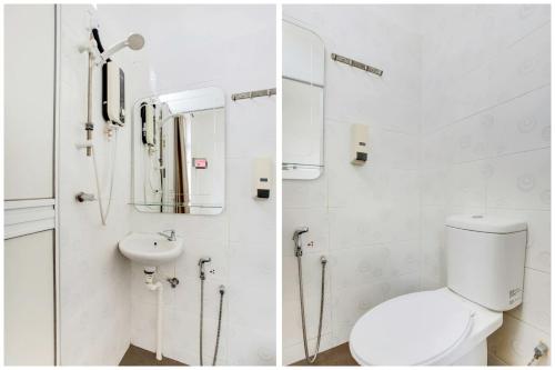 a white bathroom with a toilet and a sink at Selesa View Bukit Gambir in Bukit Gambir