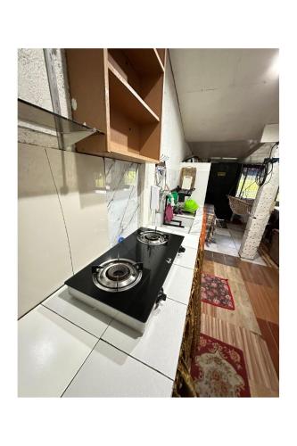 a kitchen with a black counter top in a room at Transient House in Pili, Camarines Sur Bicol in Pili