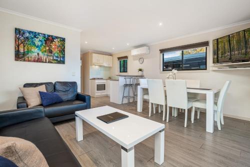 a living room with a couch and a table at BIG4 Bendigo Marong Holiday Park in Marong