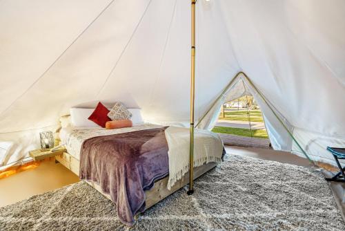 a bedroom with a bed in a tent at BIG4 Bendigo Marong Holiday Park in Marong