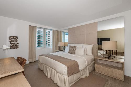 a bedroom with a large bed and a television at 1 Hotel Modern King Suite 1BR 1 5BA w Ocean View in Miami Beach