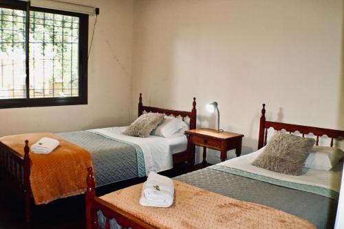 Zimmer mit 2 Betten und einem Fenster in der Unterkunft "Tu refugio espacioso en el corazón de MENDOZA y el PARQUE" in Mendoza