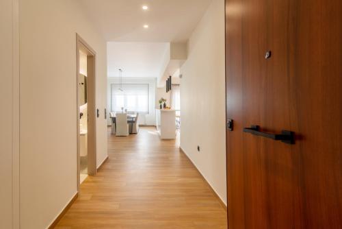 a hallway with a room with a kitchen and a hallway at Central Marousi 3BR Gem in Athens