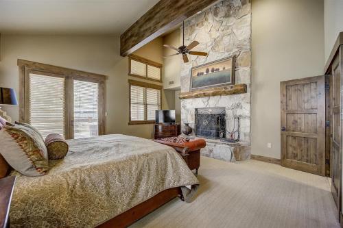 um quarto com uma cama e uma lareira de pedra em Mont Cervin 31 by AvantStay Luxury Ski in Ski out home in Park City em Park City