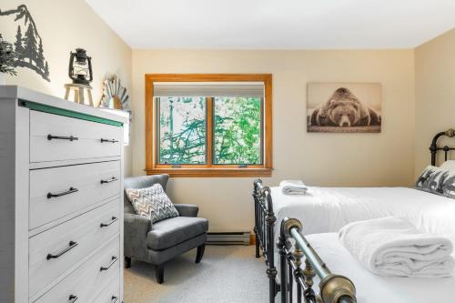 a bedroom with two beds and a chair at Cimarron Lodge 14 by AvantStay Ski-InSki-Out Property in Complex w Two Hot Tubs Permit3601 in Telluride