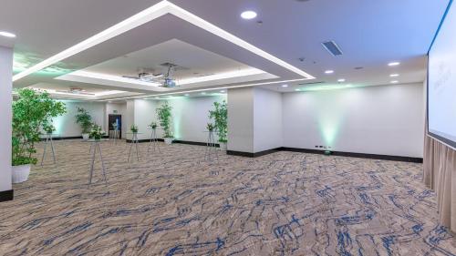 a large room with white walls and potted plants at Crowne Plaza Santo Domingo by IHG in Santo Domingo