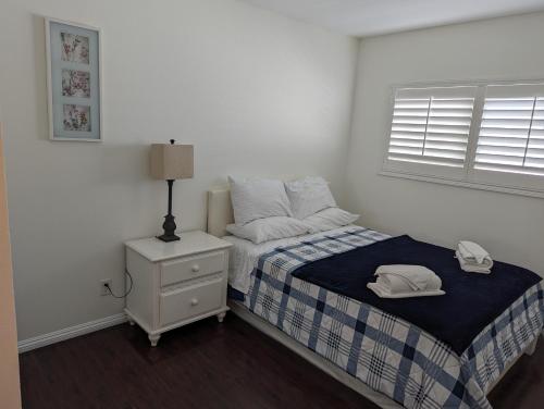 a bedroom with a bed with a nightstand and a window at 2Bedroom with Den and 2BA 4 Blocks to Santa Monica Beach in Los Angeles