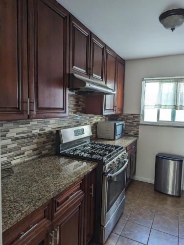 a kitchen with wooden cabinets and a stove top oven at 2Bedroom with Den and 2BA 4 Blocks to Santa Monica Beach in Los Angeles
