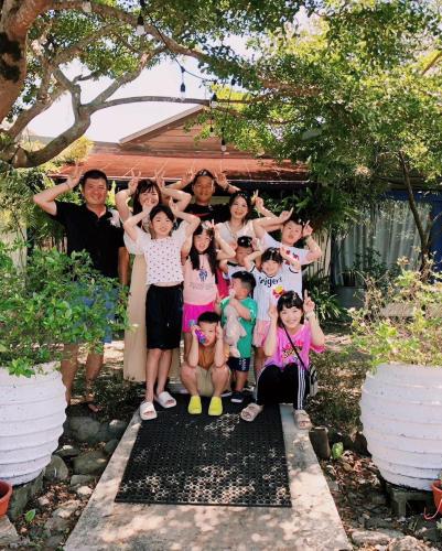 a group of people are posing for a picture at Follow Me designed B&B in Dongshan