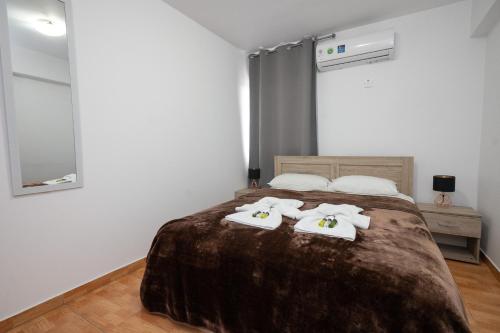 a bedroom with a bed with two towels on it at Napa Centrale Suites in Ayia Napa